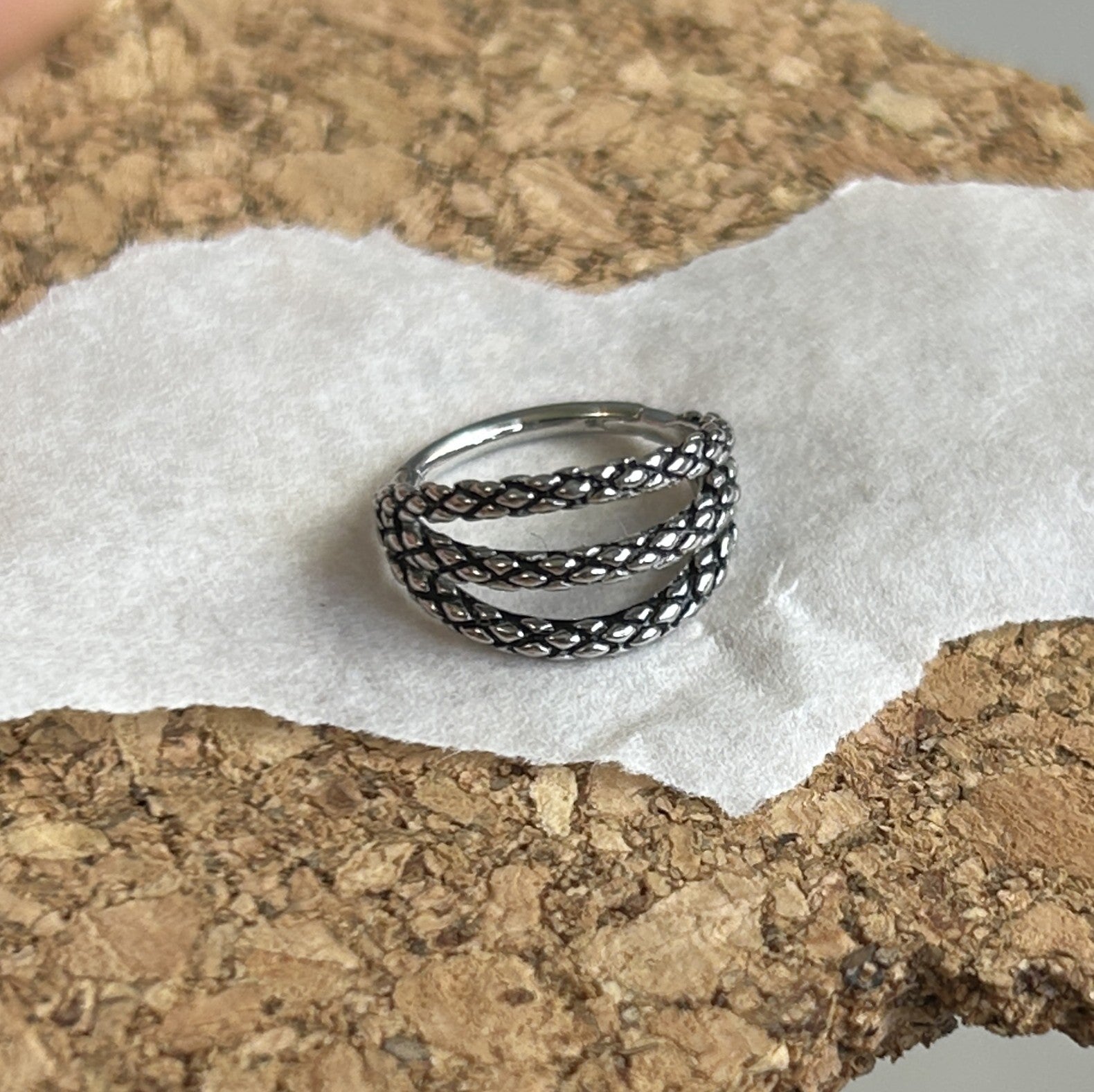 Steel triple clicker in a snake skin pattern