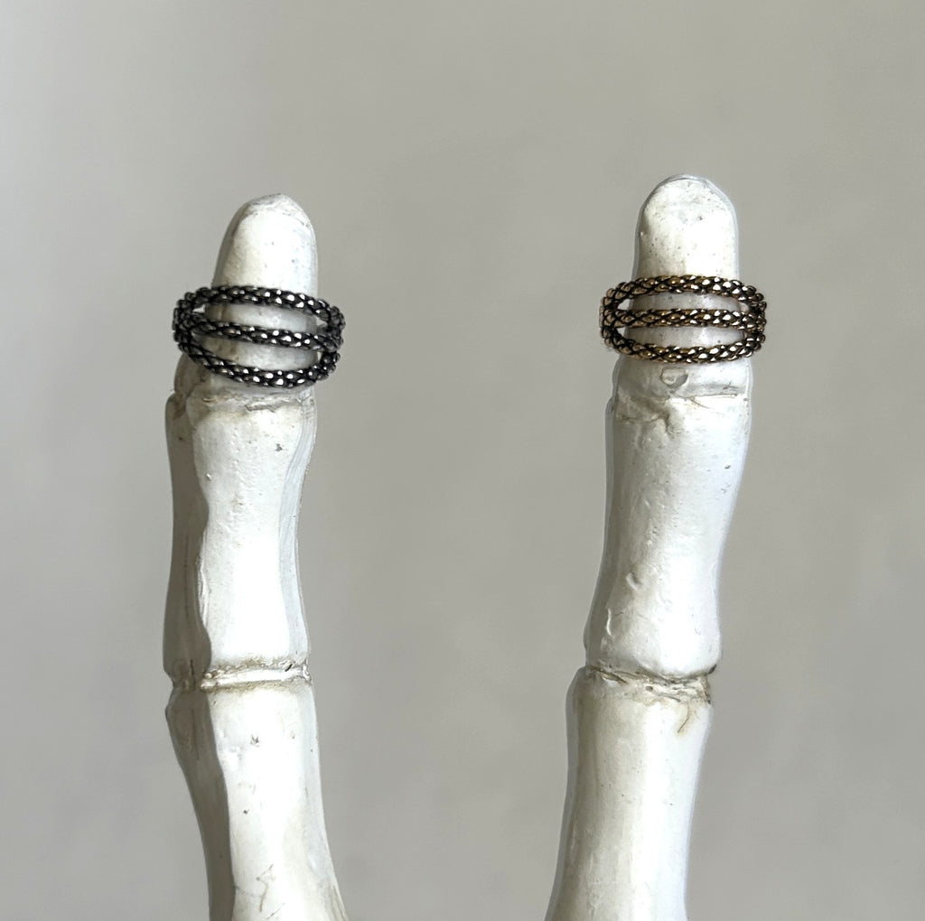 Steel triple clicker in a snake skin pattern